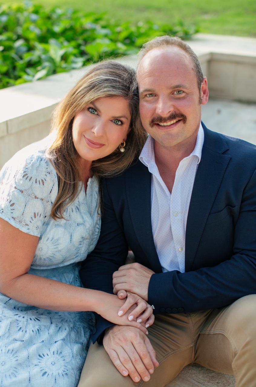 Erin and Isaac seated together outdoors